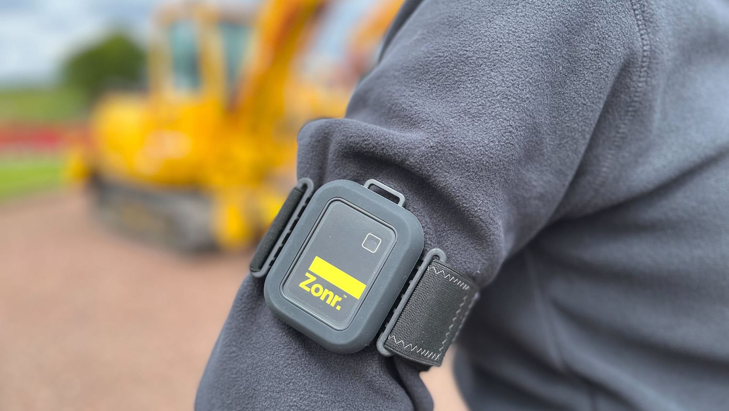 The Zonr sensor being worn on a site worker's sleeve