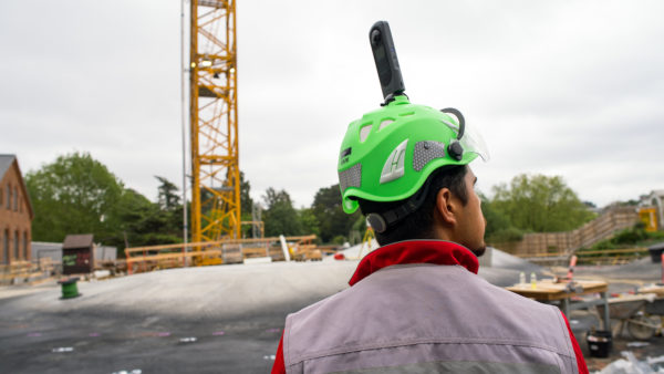 Dalux SiteWalk construction site monitoring technology on a hard hat