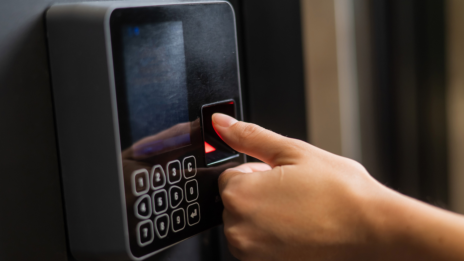 data ethics - A woman uses her fingerprint to open a door