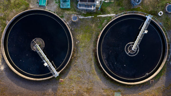 Aerial view of the tanks of a UK sewage and water treatment plant enabling the discharge and re-use of waste water and re-use of waste water