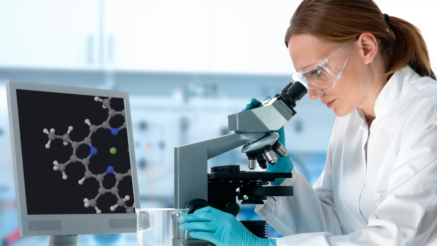 lab design image - woman using a microscope in a lab