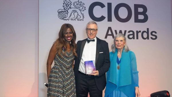 Barry Kingscote flanked by the host of the award, June Sarpong OBE (left), and CIOB’s president Sandi Rhys-Jones